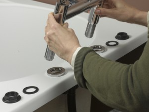 Lowering in new bath taps