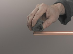 Cleaning copper pipe with steel wool