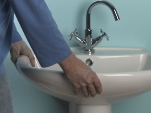 lifting new basin onto pedestal