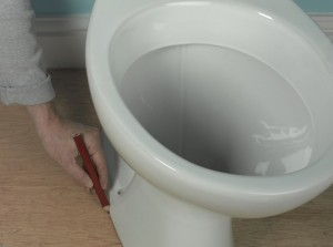 making pencil guideline around the edge of the toilet pan