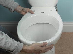 pushing toilet into pan connector