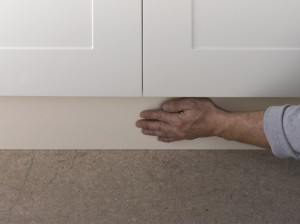 pressing kitchen plinth in position