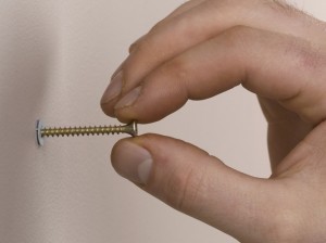 inserting screw into plasterboard