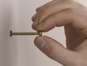 inserting screw in wall plug