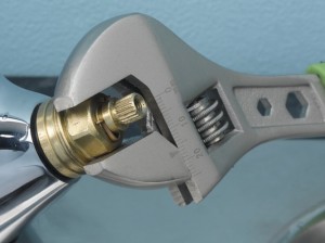Using adjustable spanner to undo tap valve