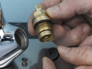 Replacing old rubber tap washer with new one to fix leak