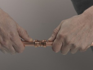 Pushing copper pipe into joint