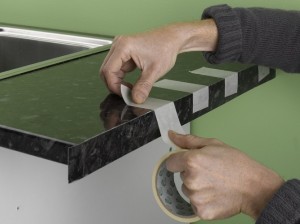 using masking tape to hold worktop edging strip in place