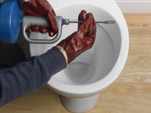 Using an auger to unblock toilet