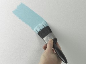 painting a wall with a brush