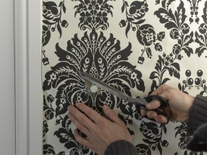 cutting wallpaper at fitting