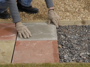 Dry laying paving slabs