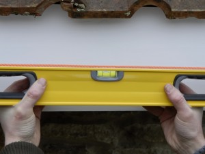 hold spirit level against taut string line