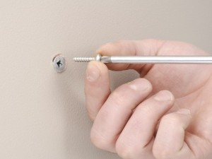 Inserting screw into spiral plug.