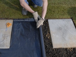 rolling out weedproof membrane