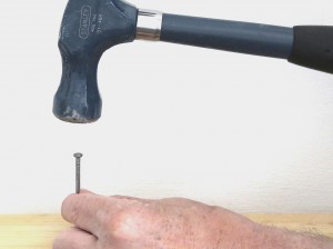 Setting a nail with a hammer